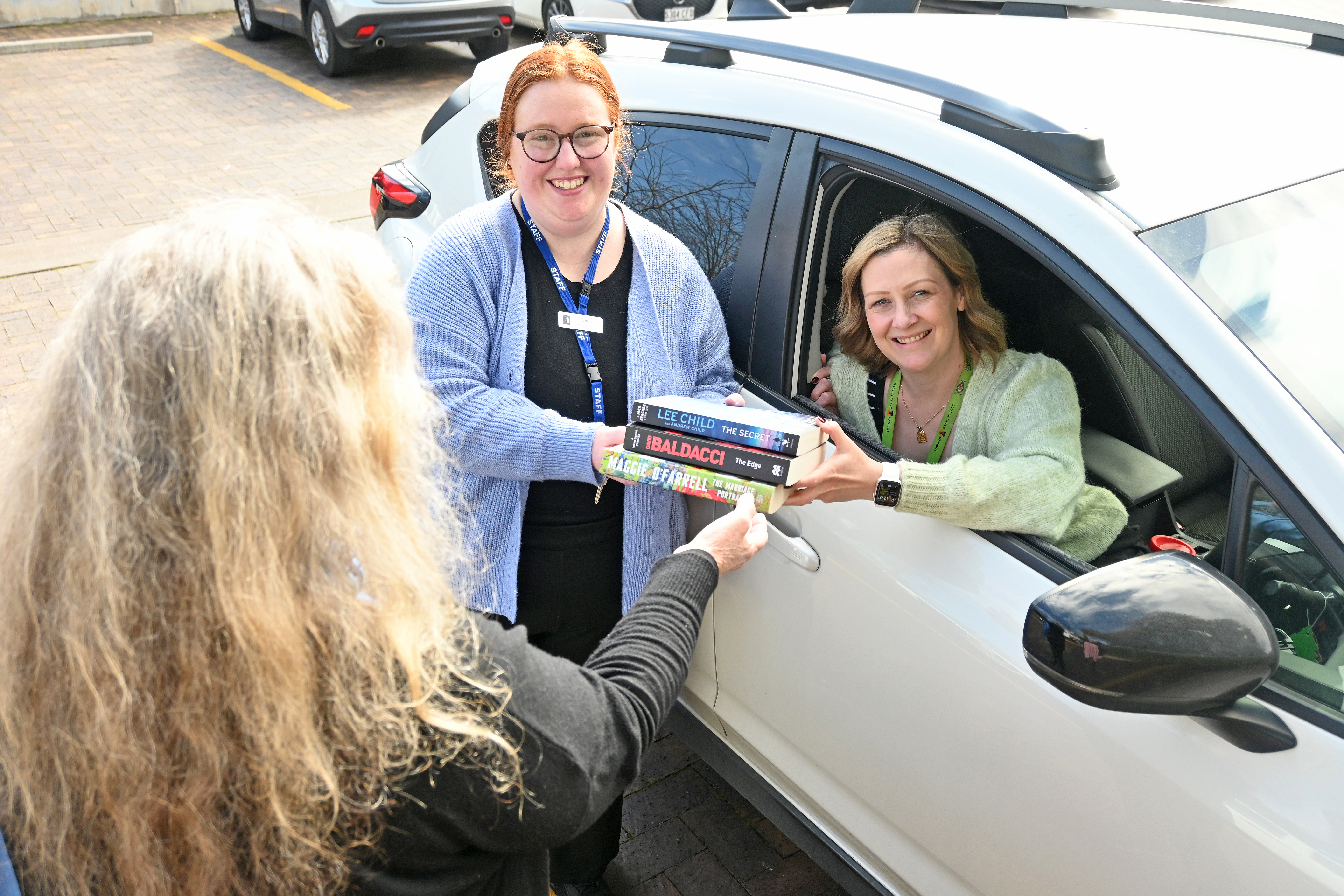 Photo of librarians delivering library books
