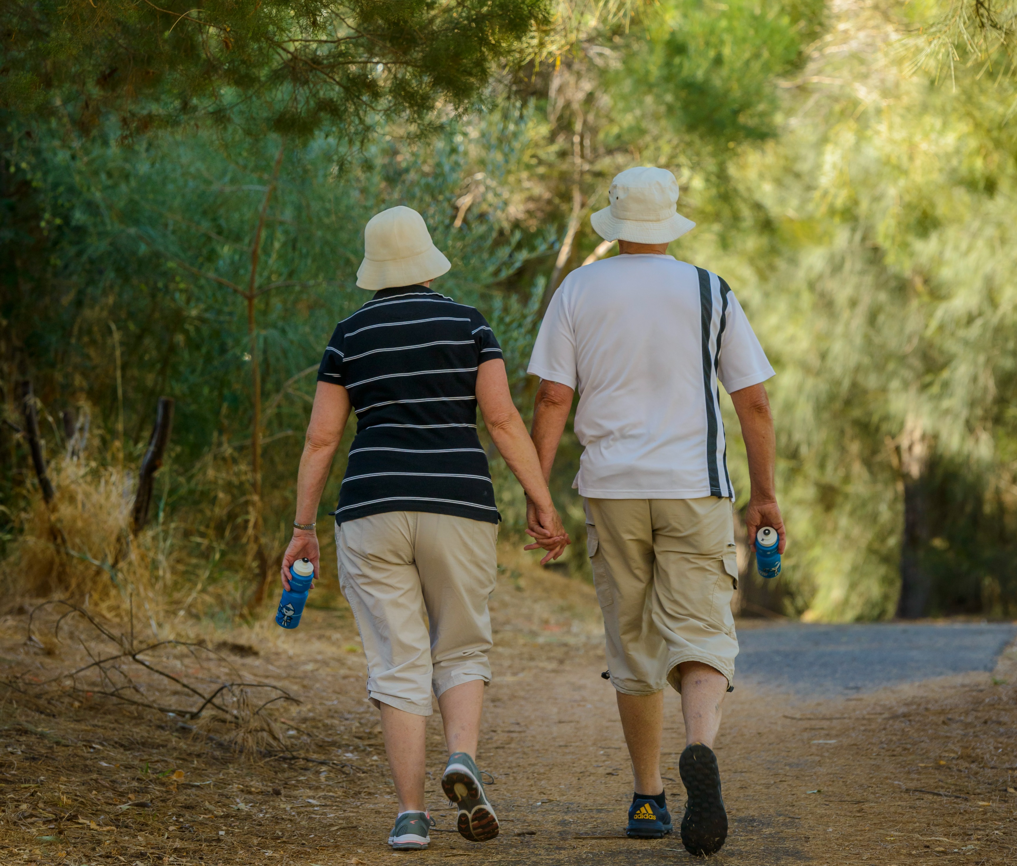 An elderly couple walking along the River Torrens.